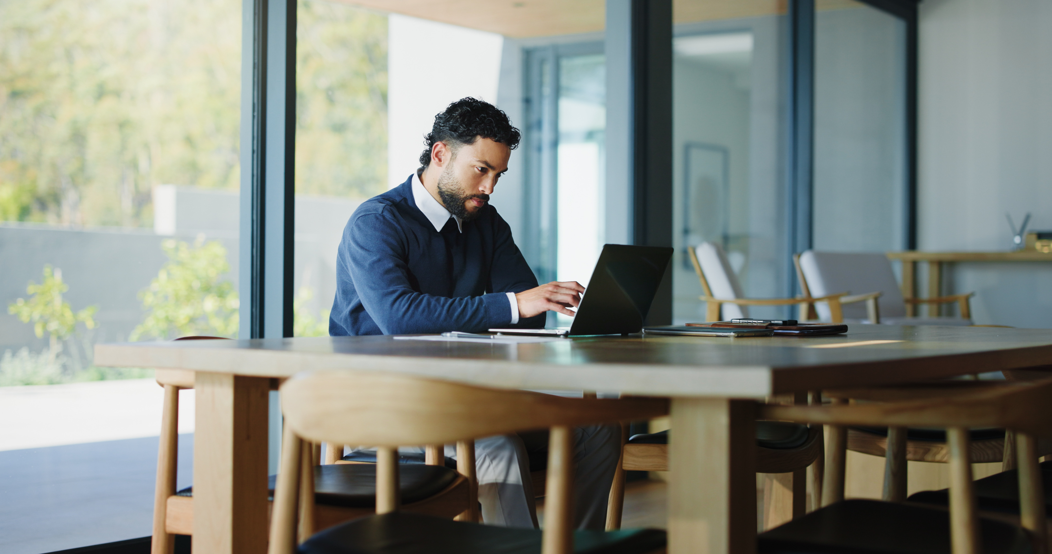 Real estate broker in office weighing cost options for commercial lending platform.