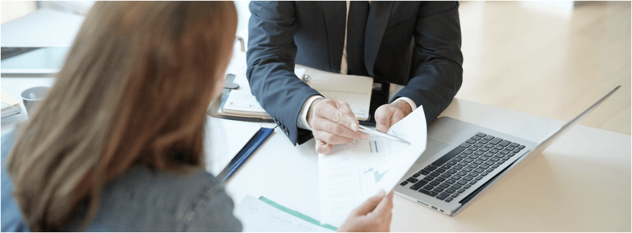 Closeup of two people reviewing loan documentation at a desk