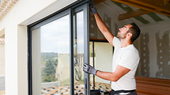 A worker installing a bay window