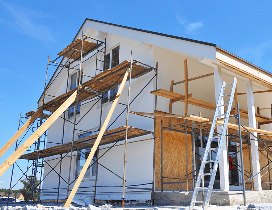 Half-painted house wall facade during exterior renovations