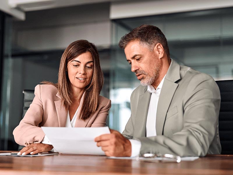 Loan-officer-discussing-financial-papers-with-client
