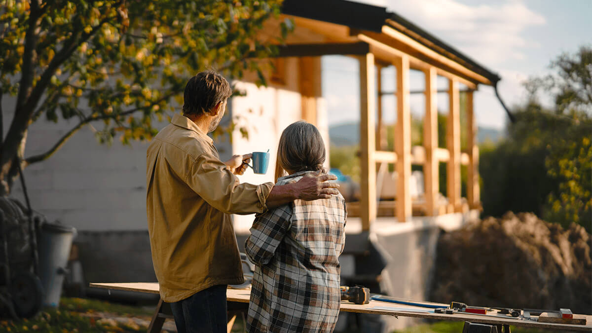 Mature-couple-looking-at-their-new-house-under-construction-1