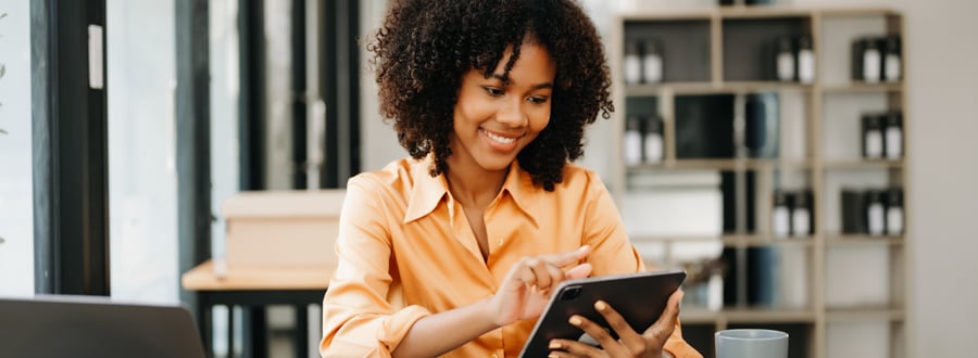 A person conducting market research on a tablet in an office