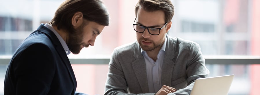 Two people working on contracts in an office