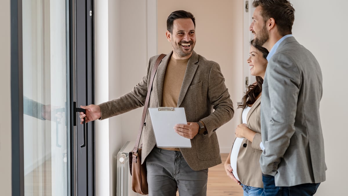 An agent showing a couple a house