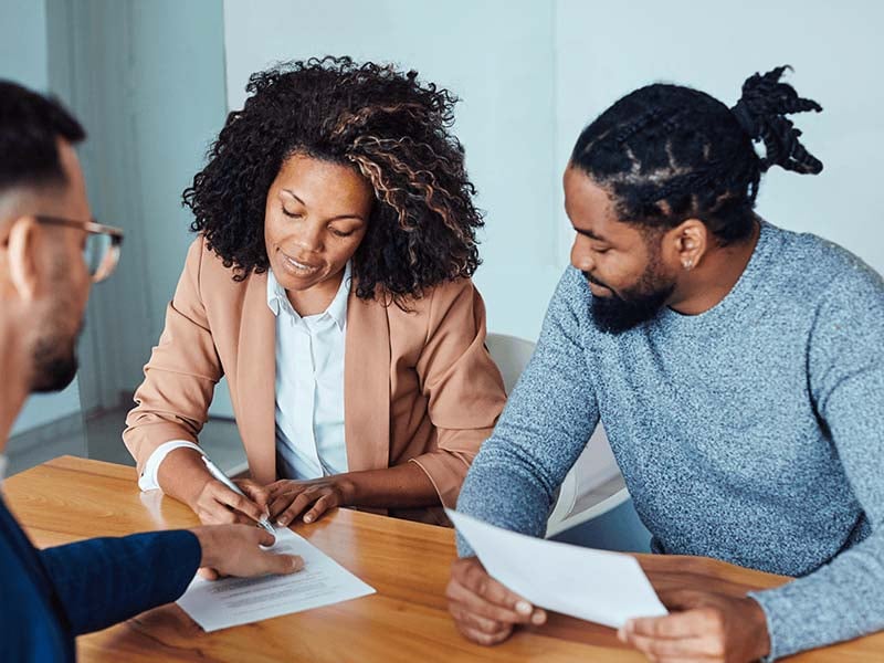 Couple-going-over-paperwork-with-loan-officer