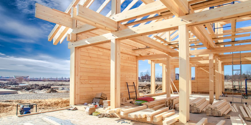 Partially built home in front of a blue sky purchased using a residential construction loan